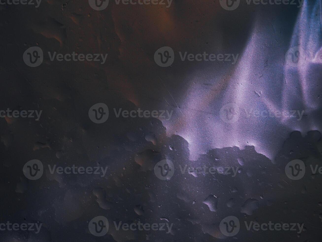 Light reflection on aluminum floor with water drops, dark background photo