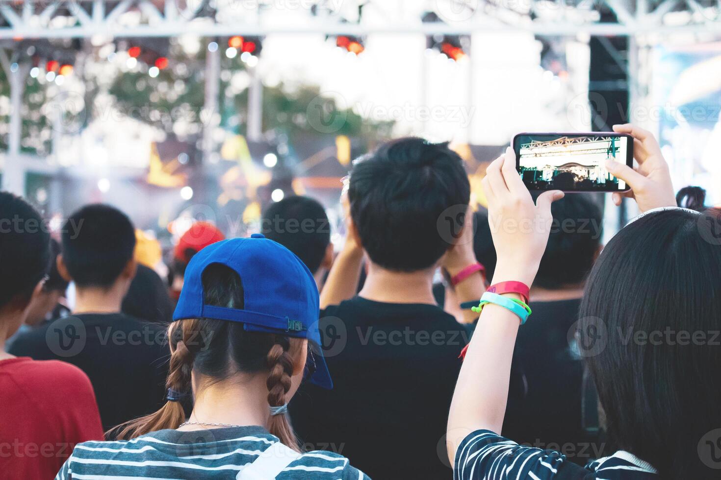 Hand with a smartphone records live music festival, Taking photo of concert stage, live concert, music festival