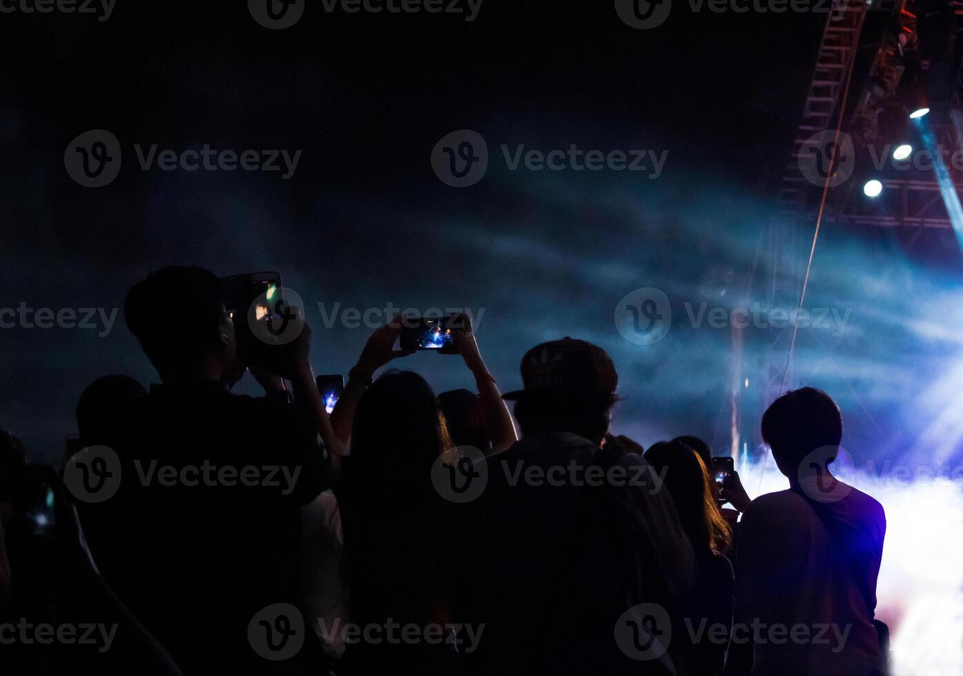 Hand with a smartphone records live music festival, Taking photo of concert stage, live concert, music festival