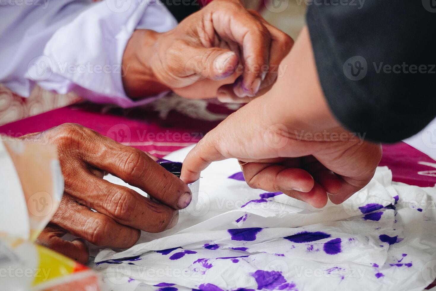 Close up portrait of little finger dipping into purple ink after voting for Indonesia President and Government Election 2024 photo