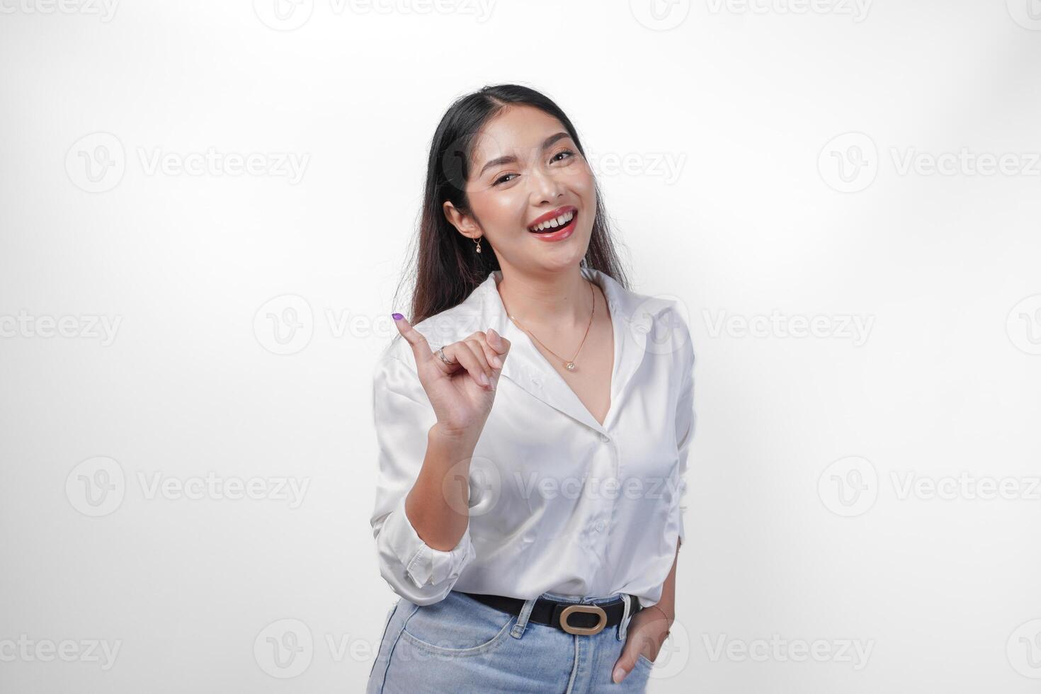 Young Asian woman proudly showing little finger dipped in purple ink after voting for president and parliament election, expressing excitement and happiness photo