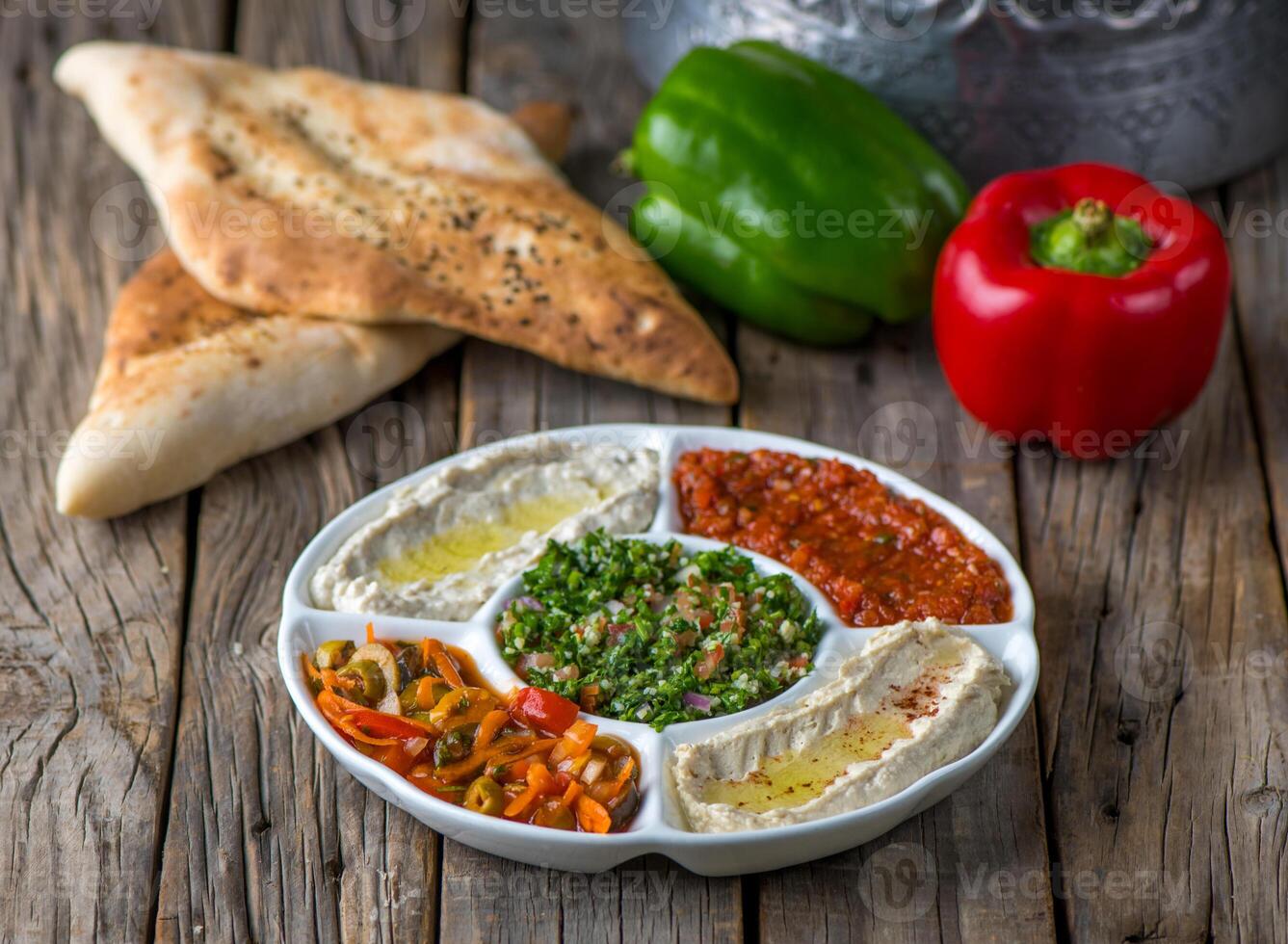 Mixed Mezza served in a dish side view on wooden table backgroundlebanese cuisine, diet food, vegan food, vegetarian cuisine, macro food, vegetables isolated, greens, syrian cuisine, veggies photo