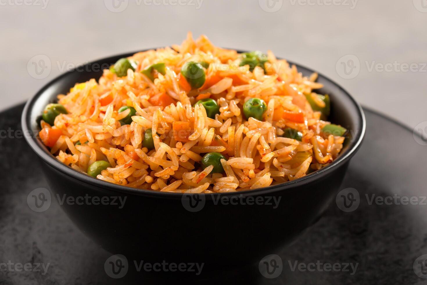 schezwan fried rice or matar pulao and chopsticks served in bowl side view of chinese food photo