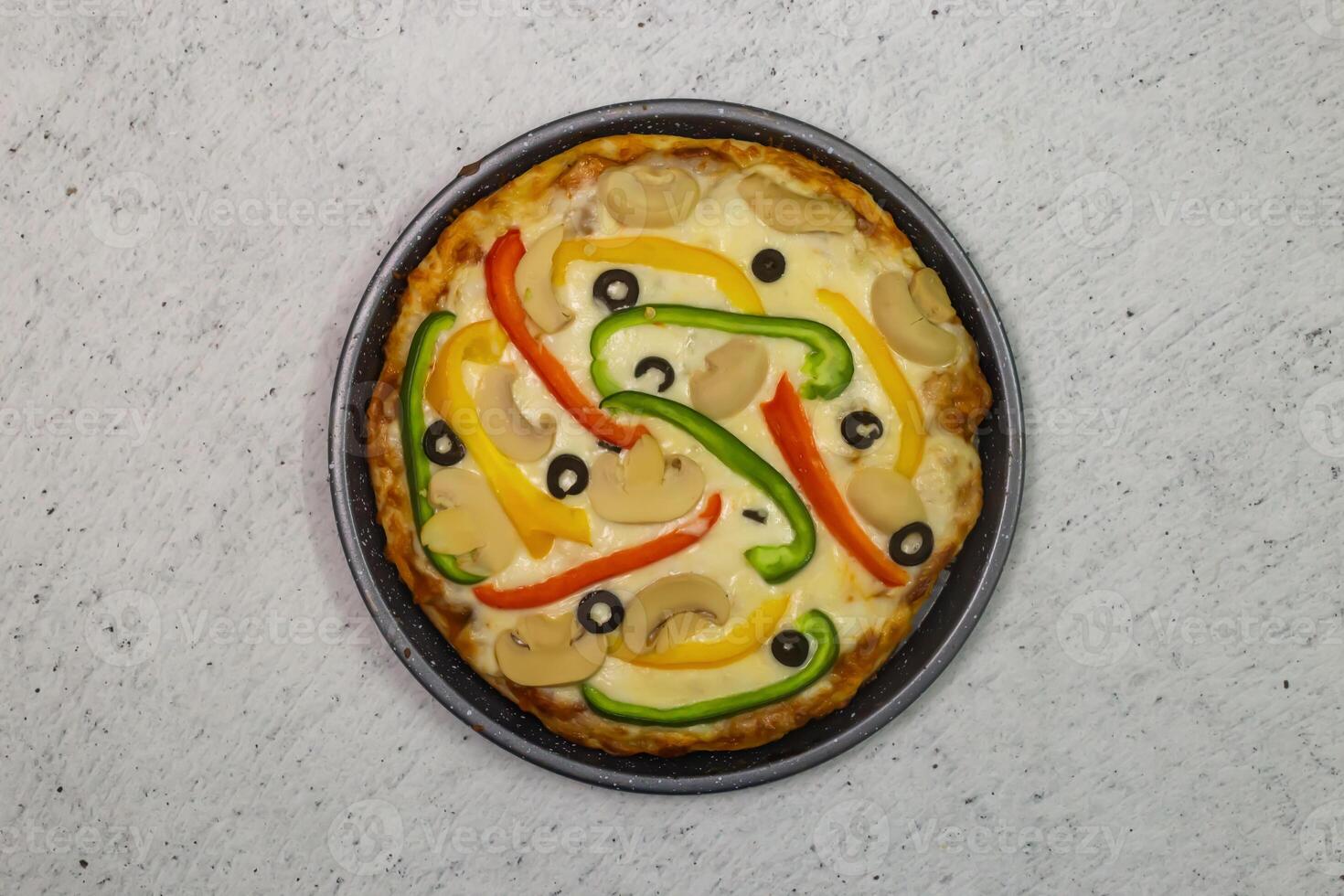 vegetable pizza topping with capsicum, olives, mushroom and cheese served in dish isolated on grey background top view of bangladeshi fastfood photo