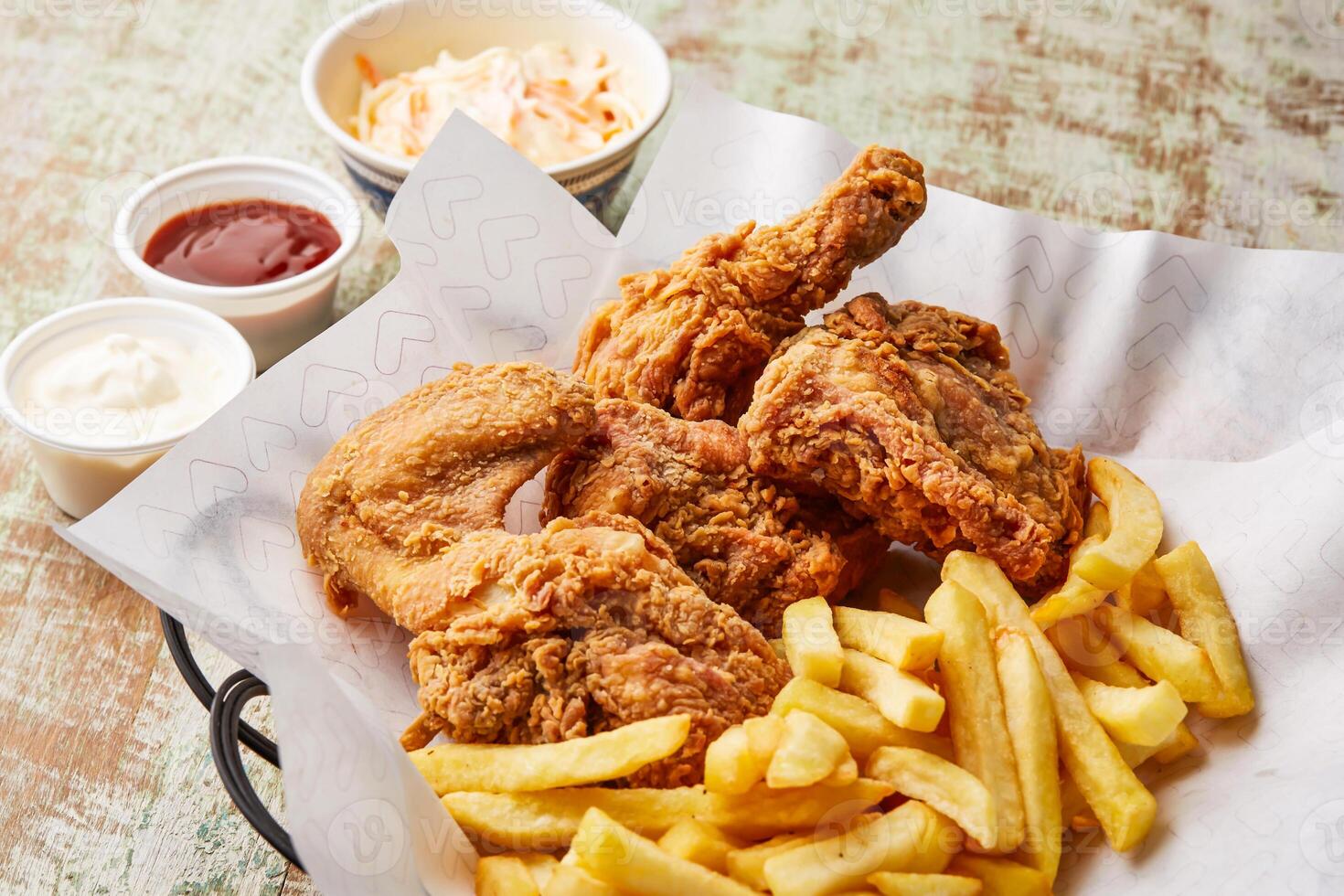 chicken broasted with french fries, chili sauce and mayo dip served in dish isolated on table top view of arabic food photo