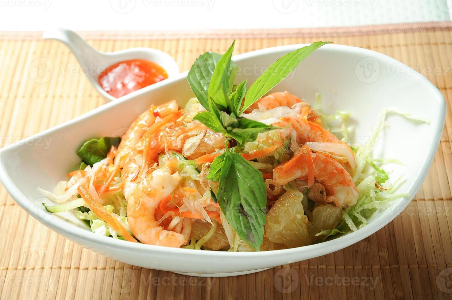 Yuzu Shrimp Salad with chilli sauce served in dish isolated on table green food photo