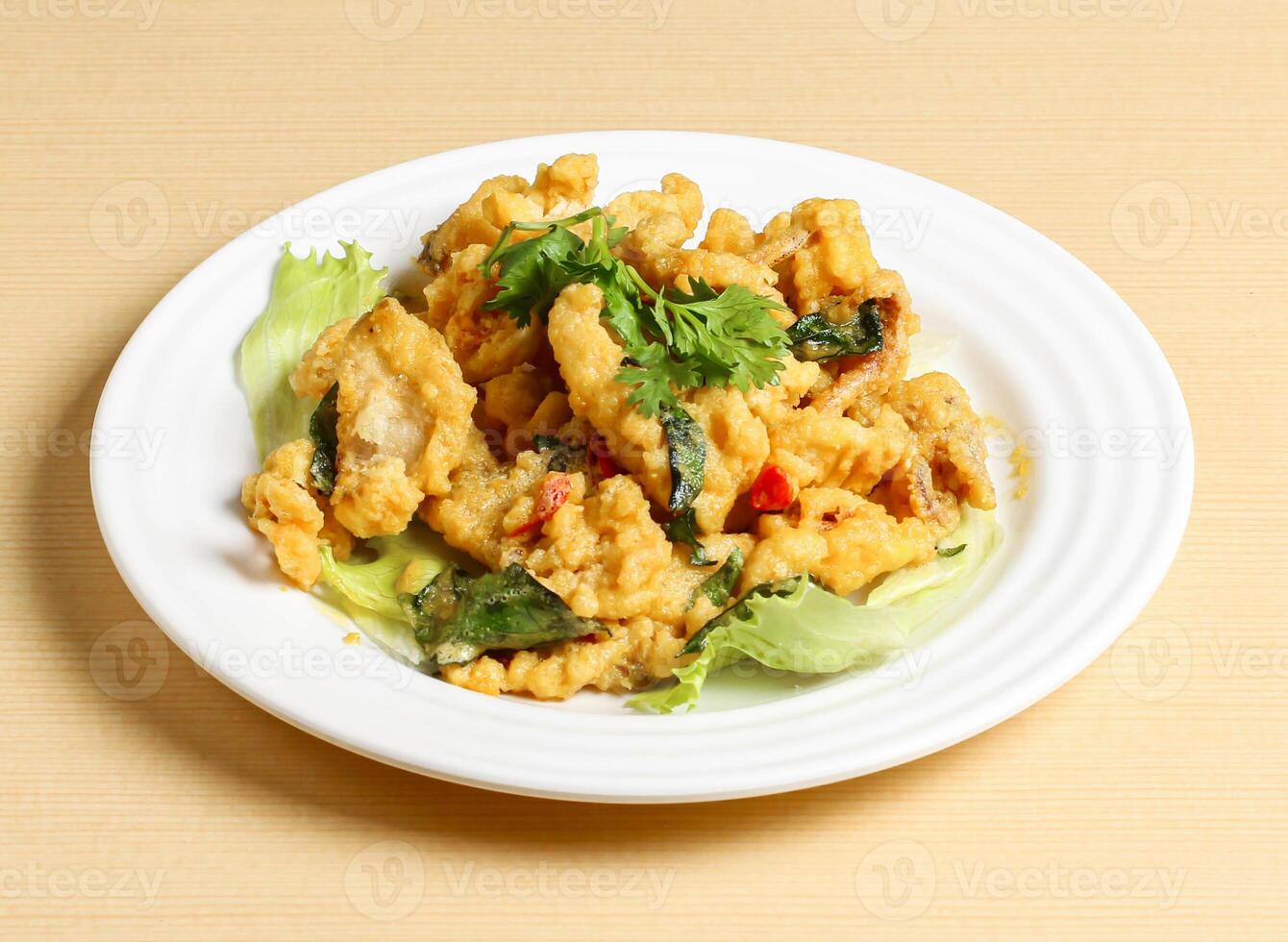 salted egg squid served in dish isolated on background top view singapore food photo