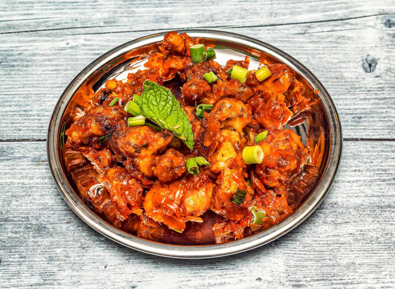 gobi manchurian served in dish isolated on wooden table top view of indian spicy food photo