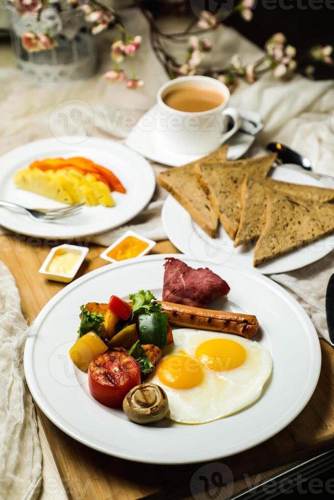 English breakfast with vegetable salad include tomato, potato, lettuce leaf and carrot with tea, coffee, and sweet melon served on food table top view healthy breakfast photo