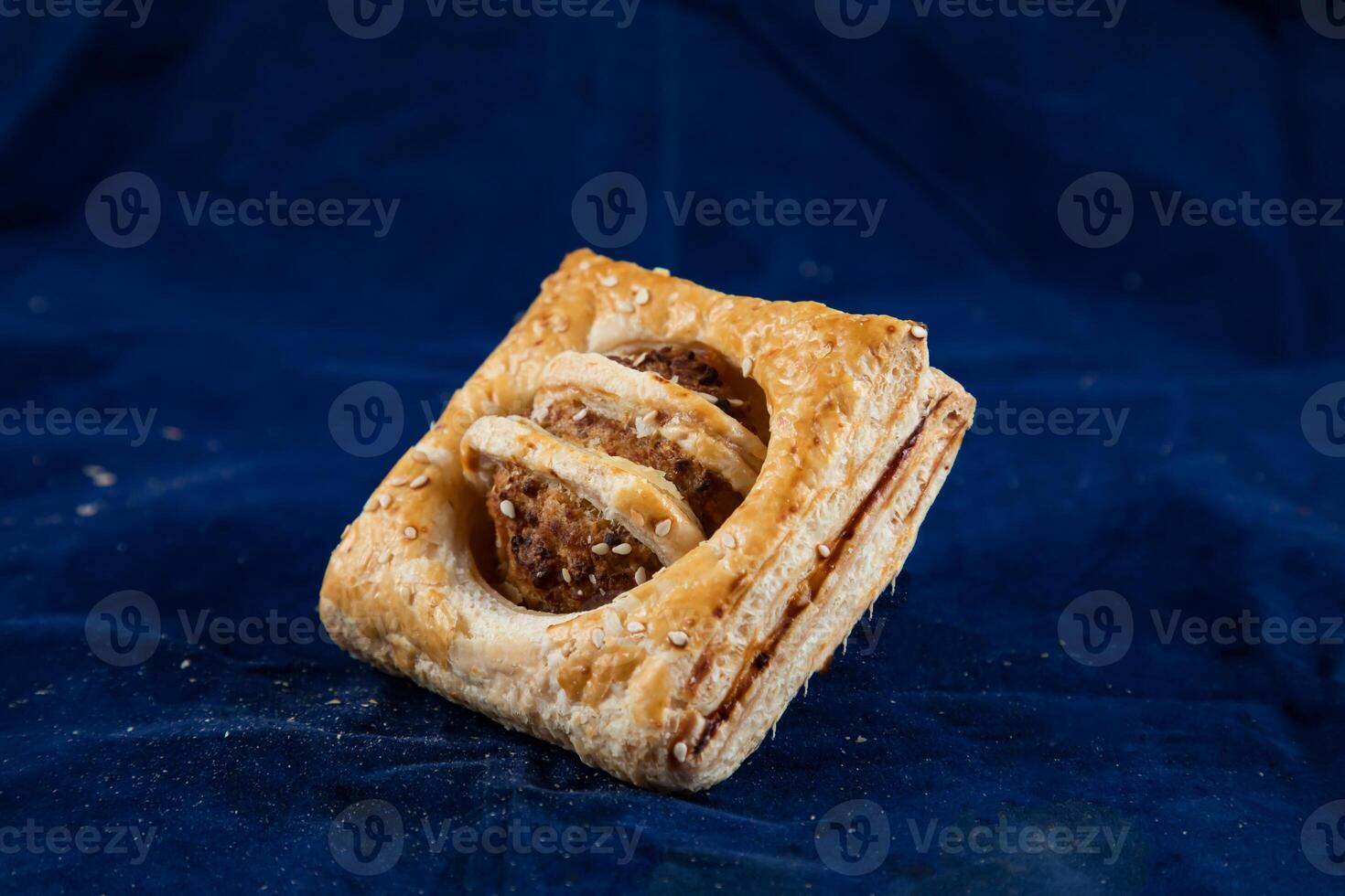 Chicken Crumb Puff isolated on blue background side view of savory snack food photo