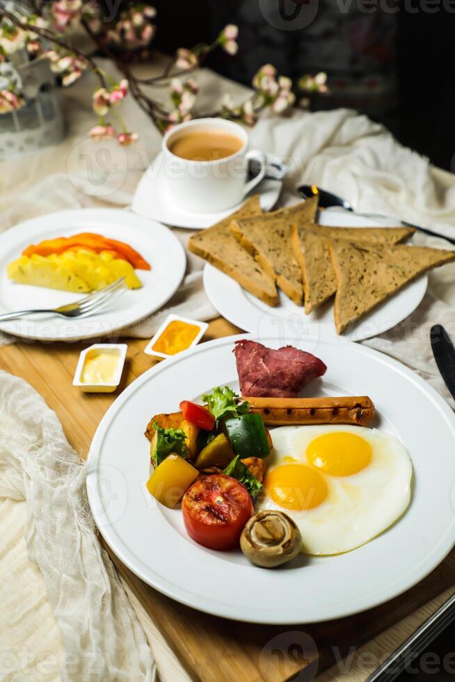 English breakfast with vegetable salad include tomato, potato, lettuce leaf and carrot with tea, coffee, and sweet melon served on food table top view healthy breakfast photo