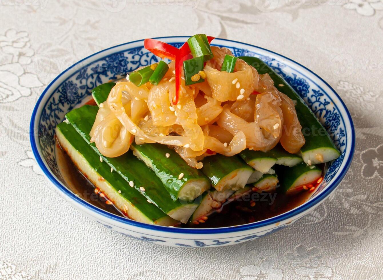 Hand Pat Cucumber Jellyfish served dish isolated on background top view of hong kong chinese food photo