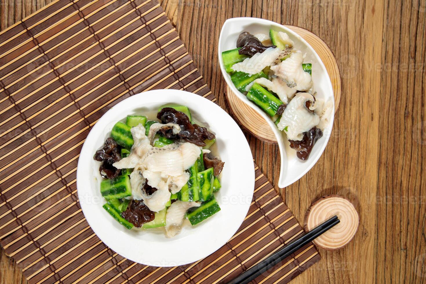 Stir-fried Snapper Fillet with Squash and Cloud Fungus with chopsticks served in dish isolated on mat top view on wooden table Hong Kong food photo