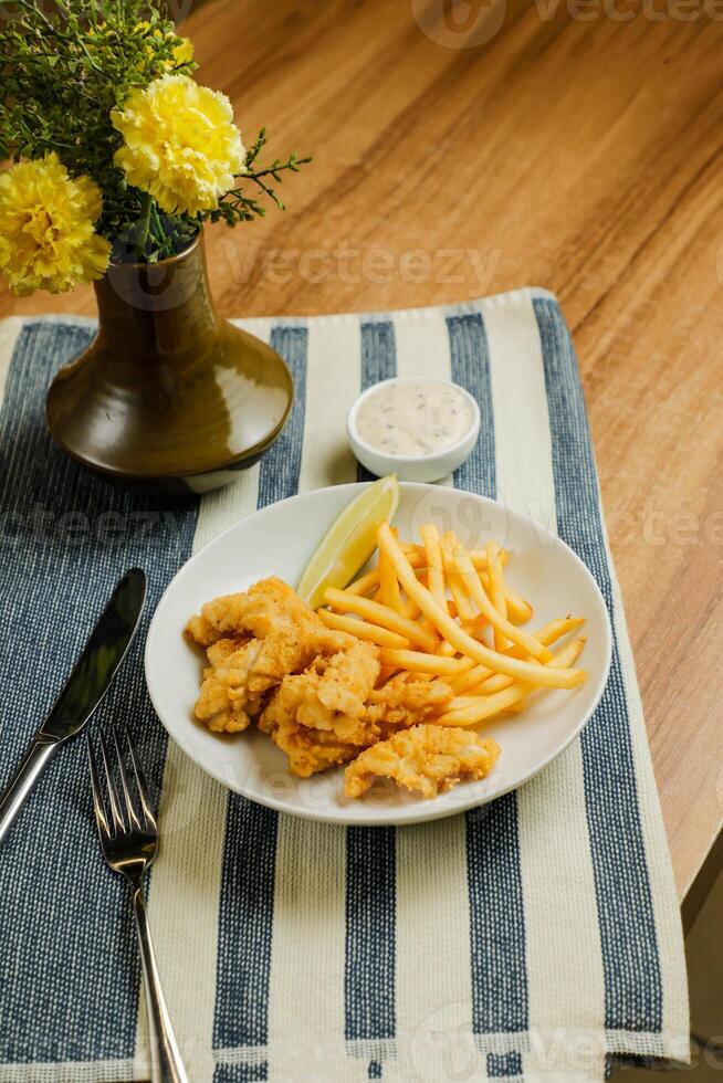 Deep Fried Garlic Mushroom with french fries, mayo dip, knife and fork served in dish isolated on table top view of fastfood appetizer photo