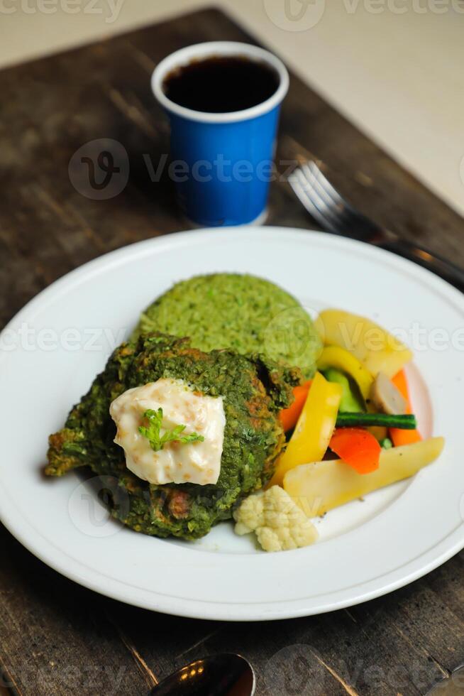 Garlic Chicken With Rice and Veg served in plate with cold drink, spoon and fork isolated on wooden board side view of thai food photo