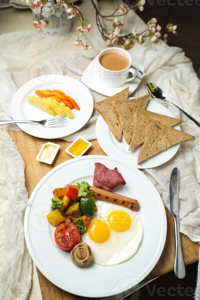 English breakfast with vegetable salad include tomato, potato, lettuce leaf and carrot with tea, coffee, and sweet melon served on food table top view healthy breakfast photo