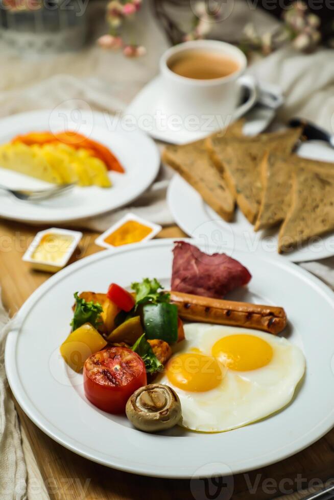 English breakfast with vegetable salad include tomato, potato, lettuce leaf and carrot with tea, coffee, and sweet melon served on food table top view healthy breakfast photo