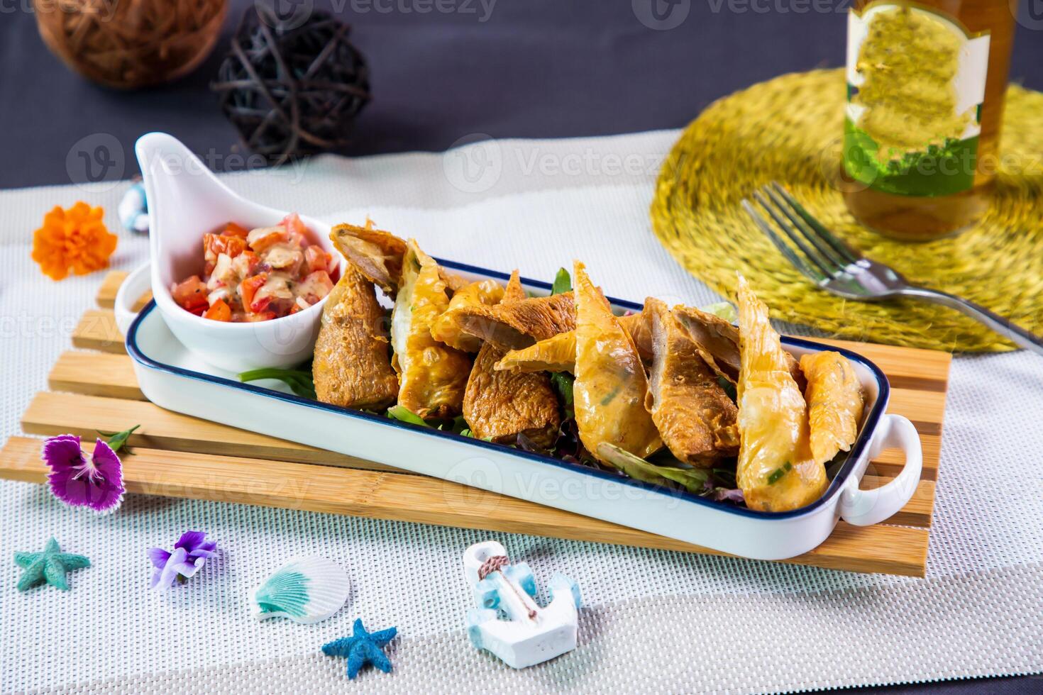 Spicy Fish Crispy Roll with sauce and tomato served in dish tray isolated i napkin side view of japanese seafood fasfood on table photo