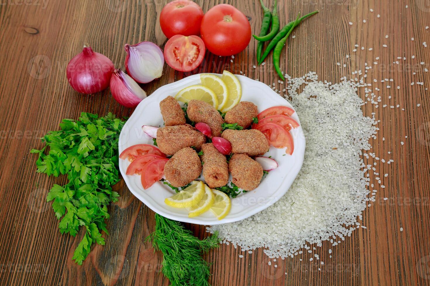 Mumbar Bites with lemon, tomato, onion, green chili and coriander served in dish isolated on table top view of arabic food photo