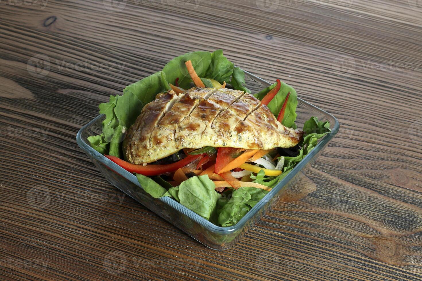 Smoked chicken salad with tomato, carrot, onion and cucumber served in dish isolated on wooden table side view of arabic food photo