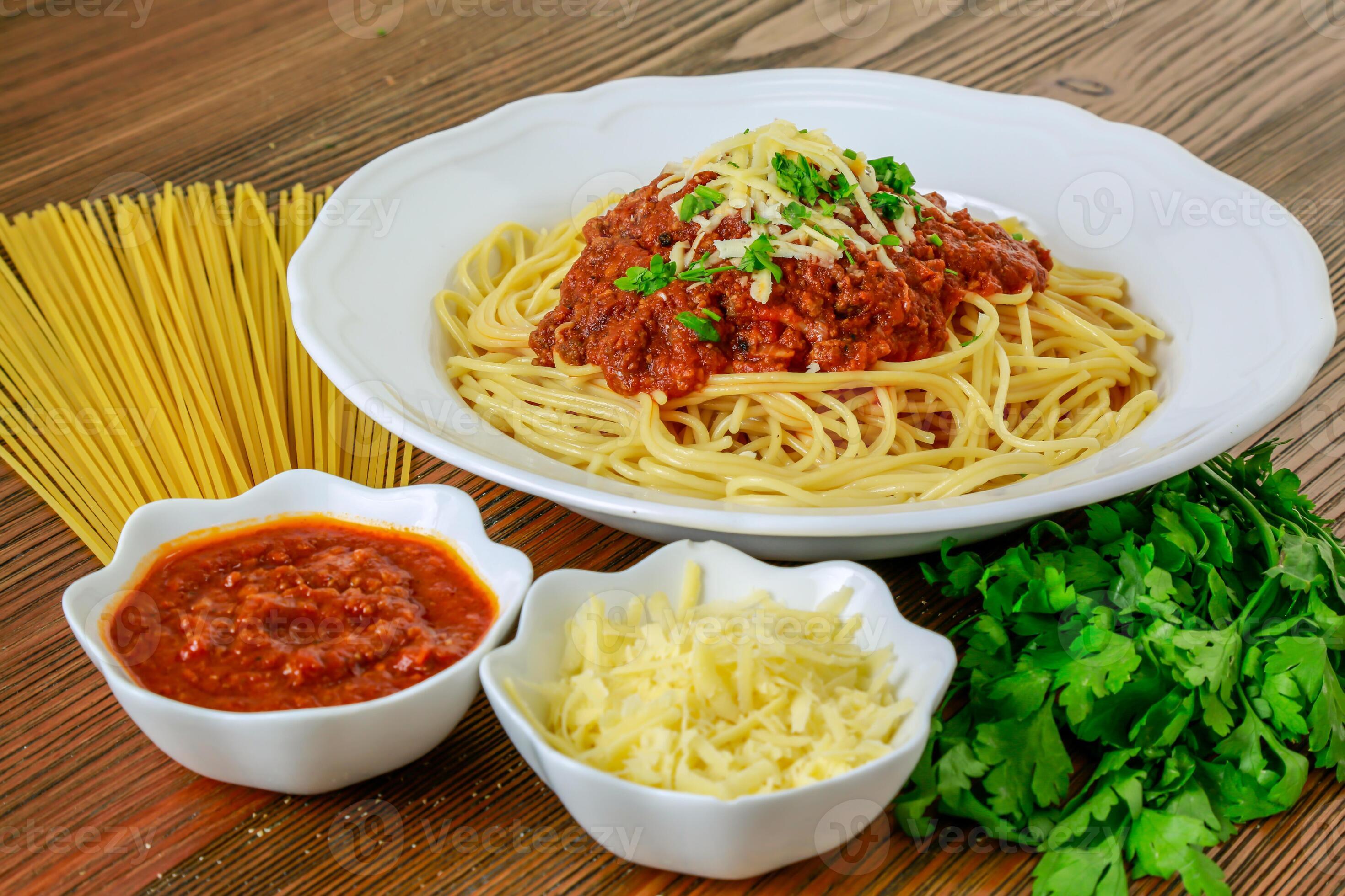 Spaghetti bolognese pasta with chili sauce paste and coriander served