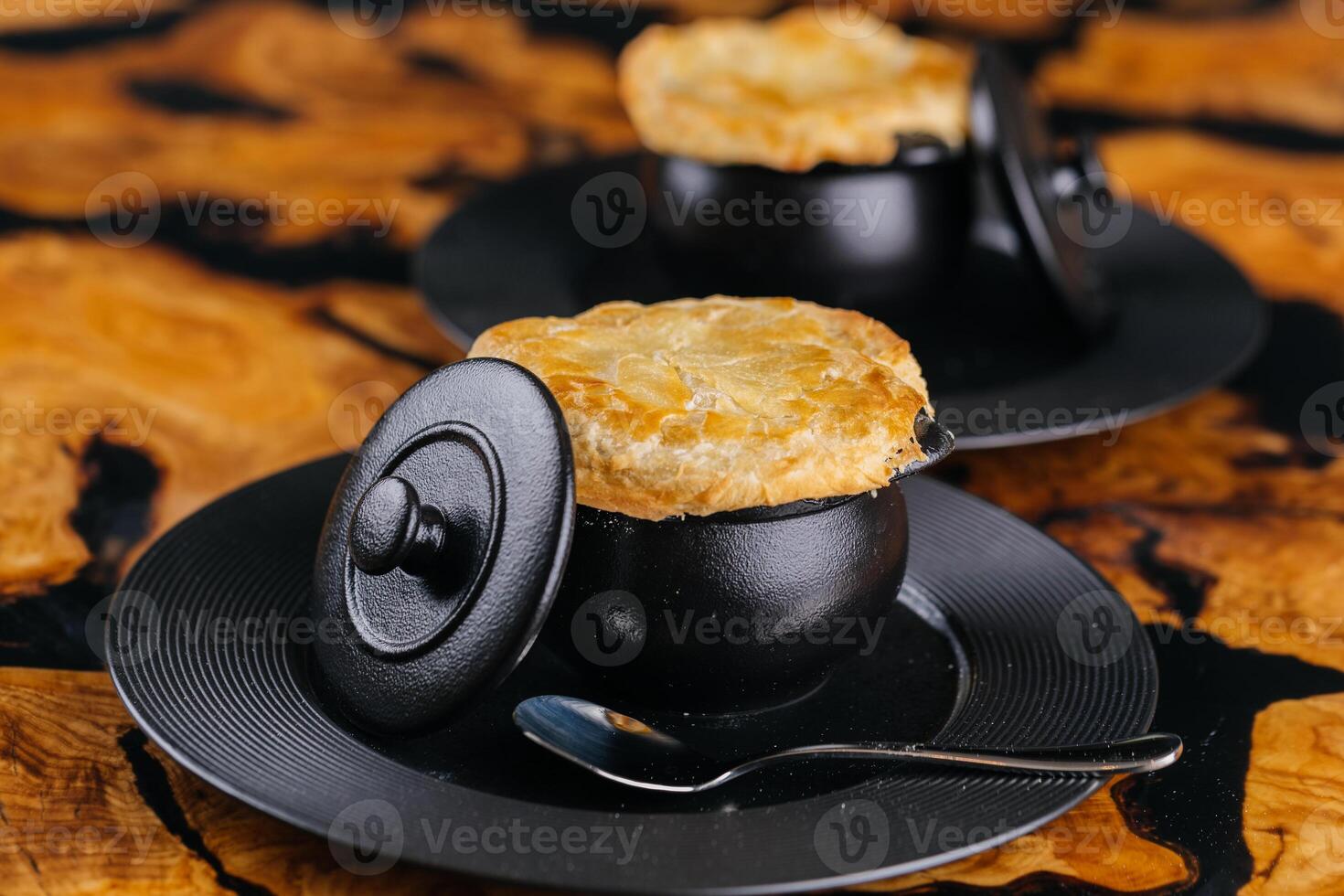 Oven Baked Cream of Mushroom soup served in pot with spoon isolated on table top view of arabic hot soup photo