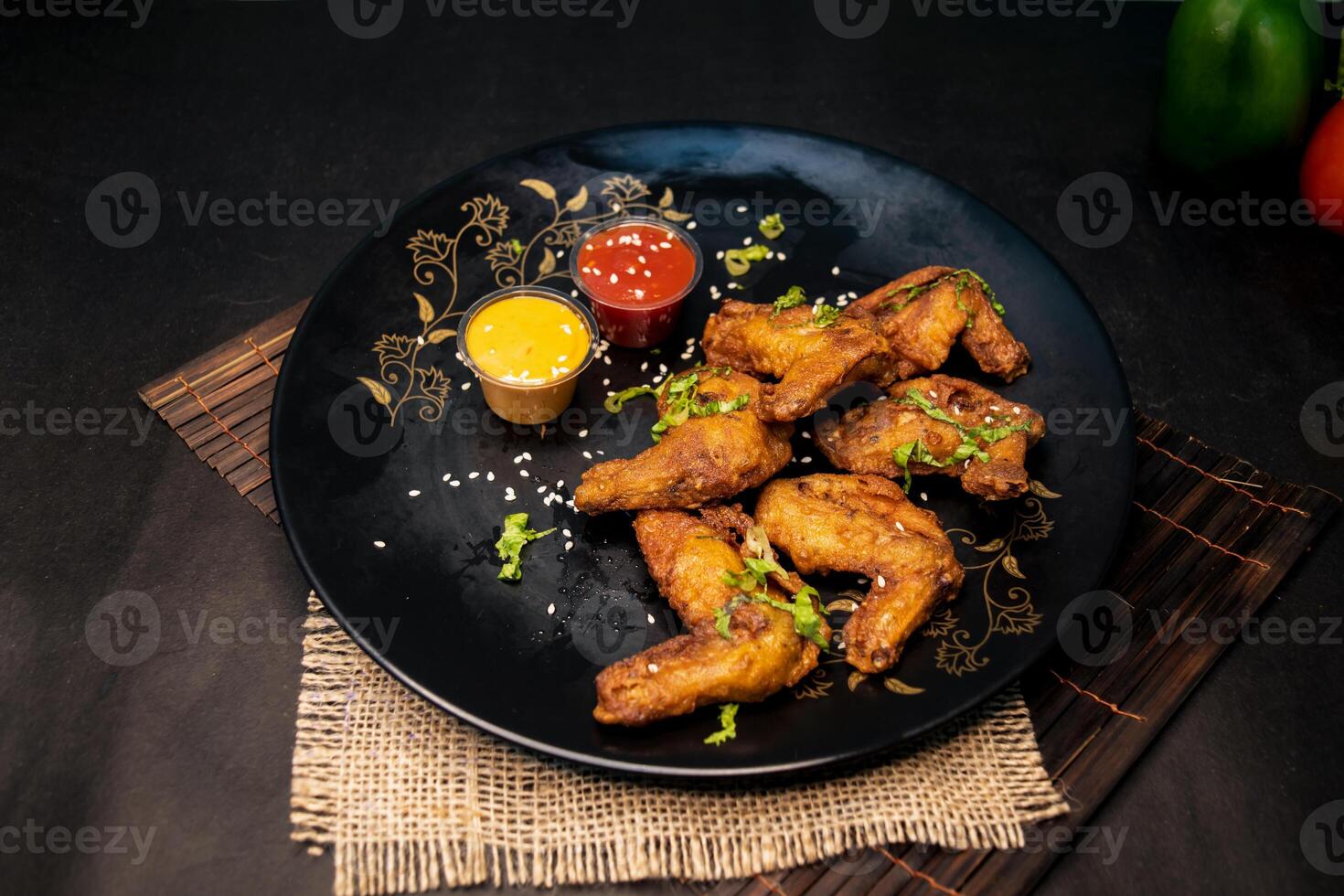 Hot Chicken Wings with chilli sauce and mayo dip served in dish isolated on napkin dark background top view of indian fastfood photo