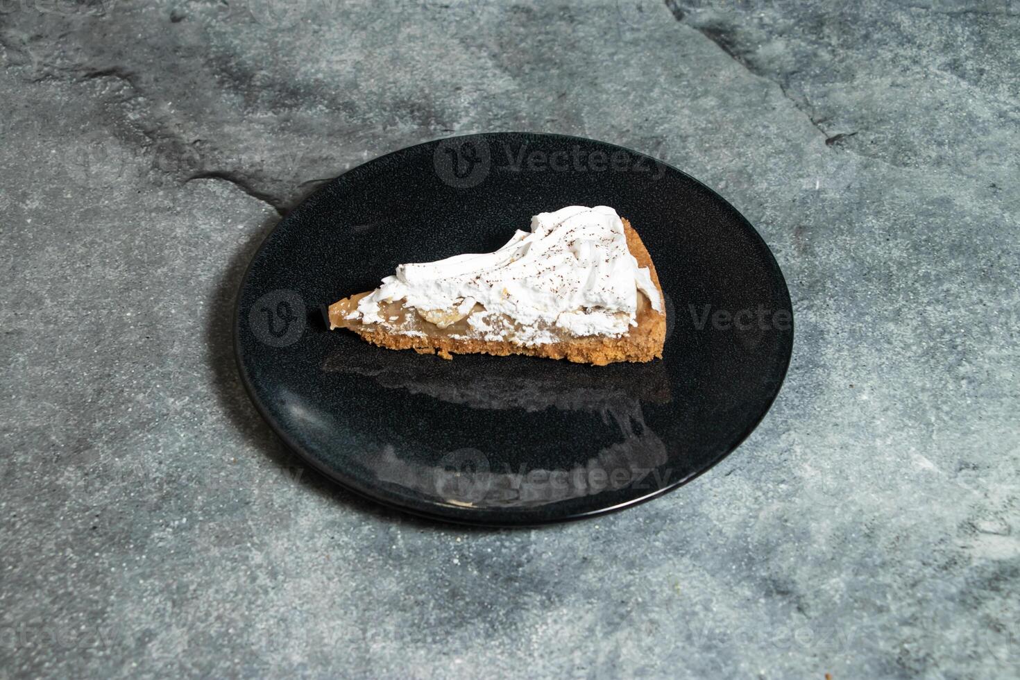 Banoffee pie with banana and cream served in plate isolated on background top view of baked food indian dessert photo