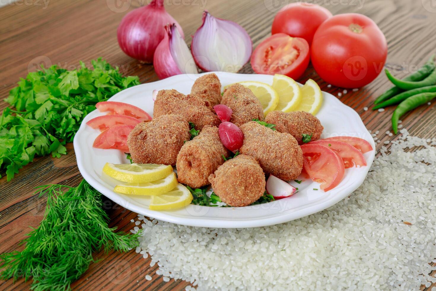 Mumbar Bites with lemon, tomato, onion, green chili and coriander served in dish isolated on table side view of arabic food photo