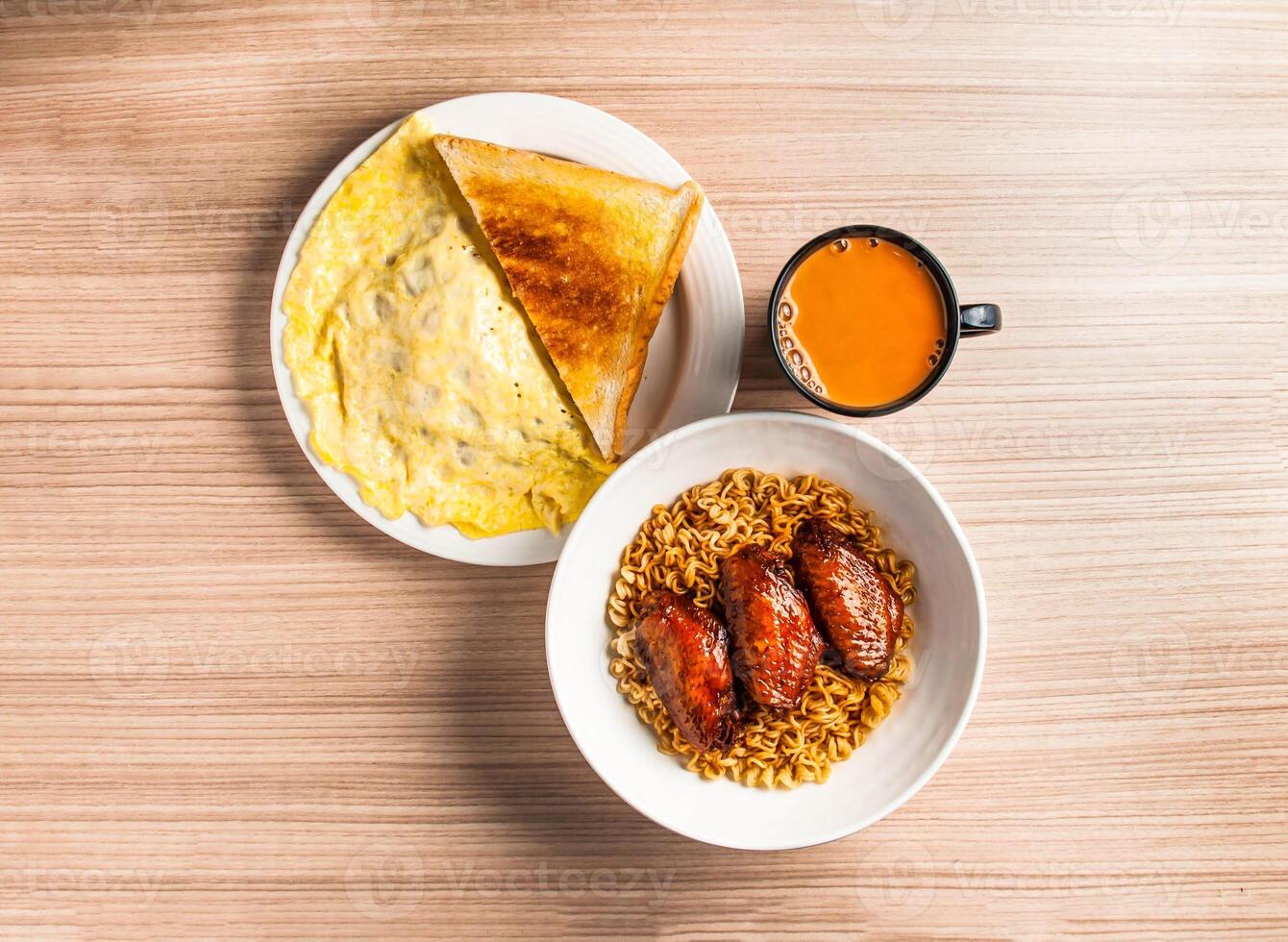 chicken wings noodles set with omelette, bread toast and coffee served in dish isolated on table top view of hong kong breakfast food photo