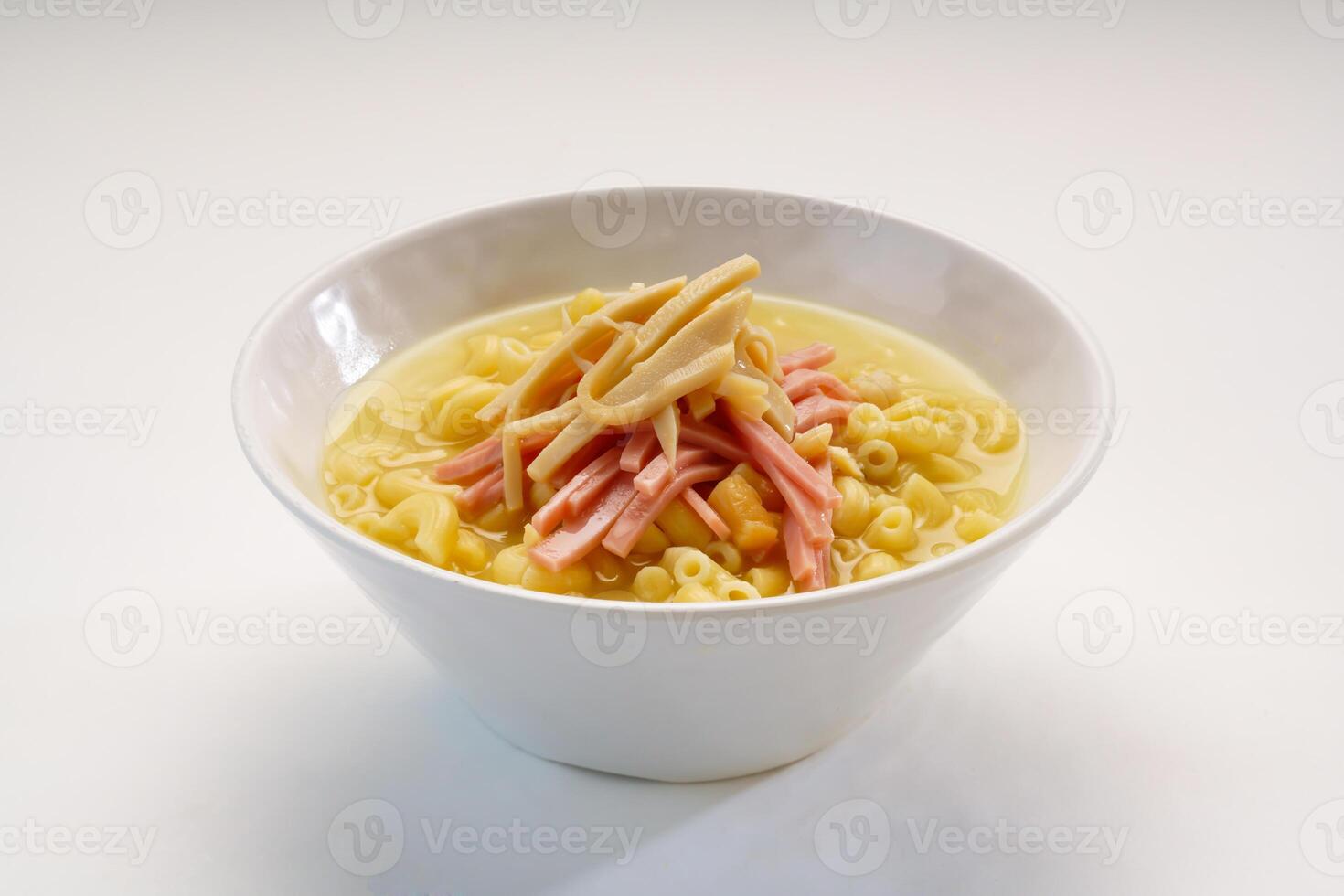 Imitation abalone and ham pasta served in bowl isolated on wooden table side view of hong kong fast food photo