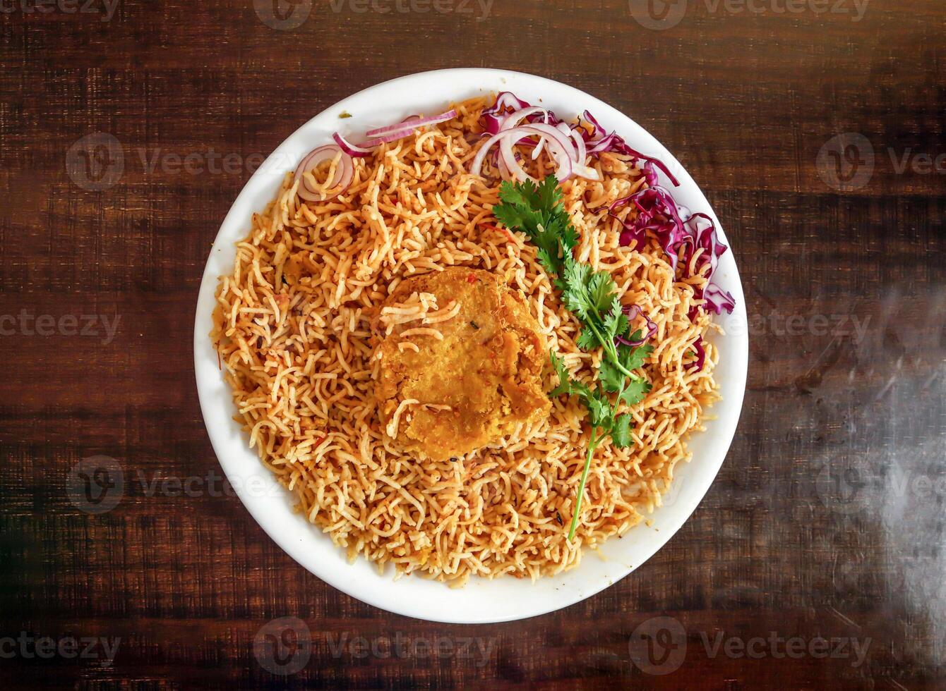 Plain pulao with shami kabab onion and cabbage served in plate isolated wooden background top view indian spices and pakistani food photo