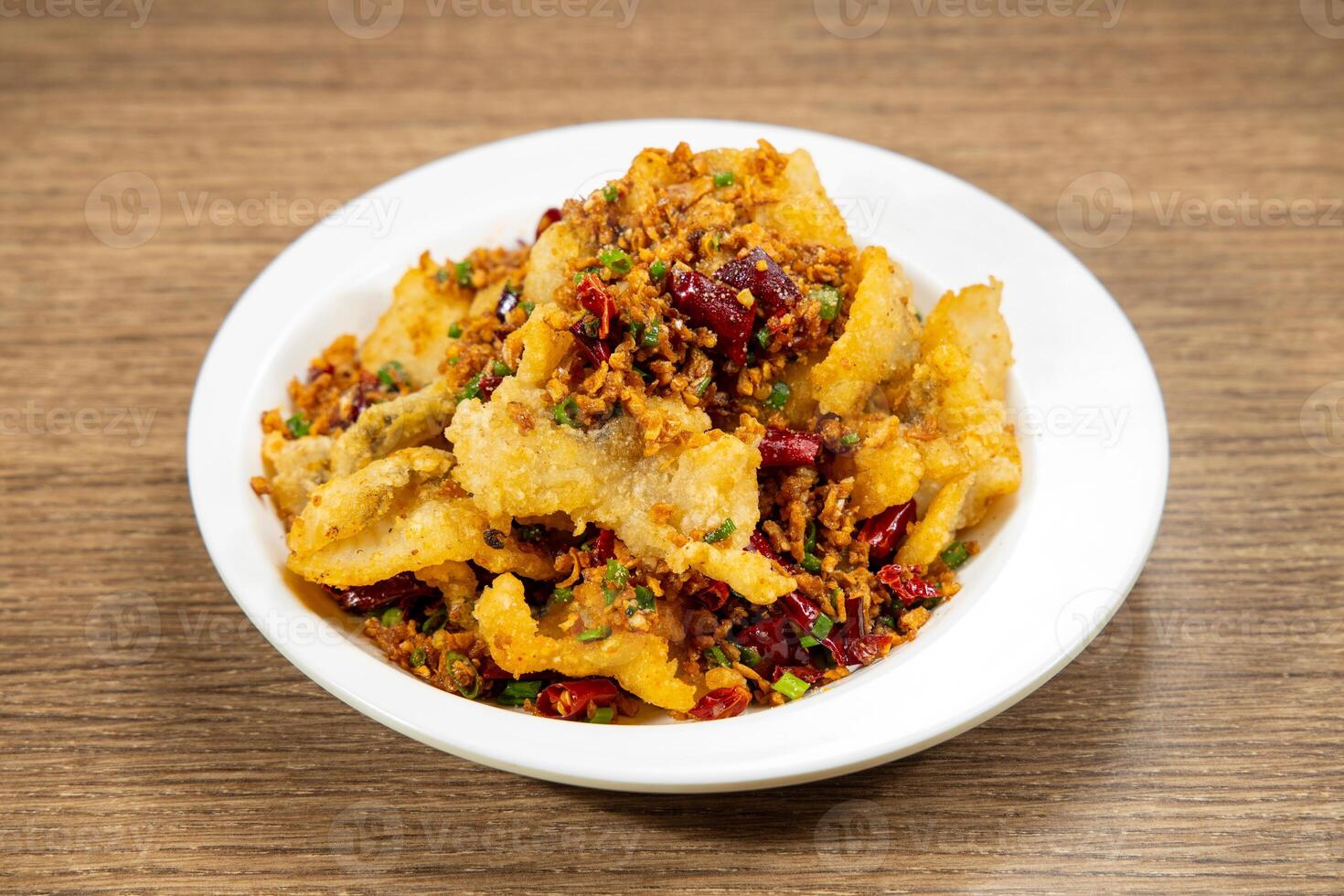 red chilli fried fish fillet served in dish isolated on mat top view on wooden table Hong Kong food photo