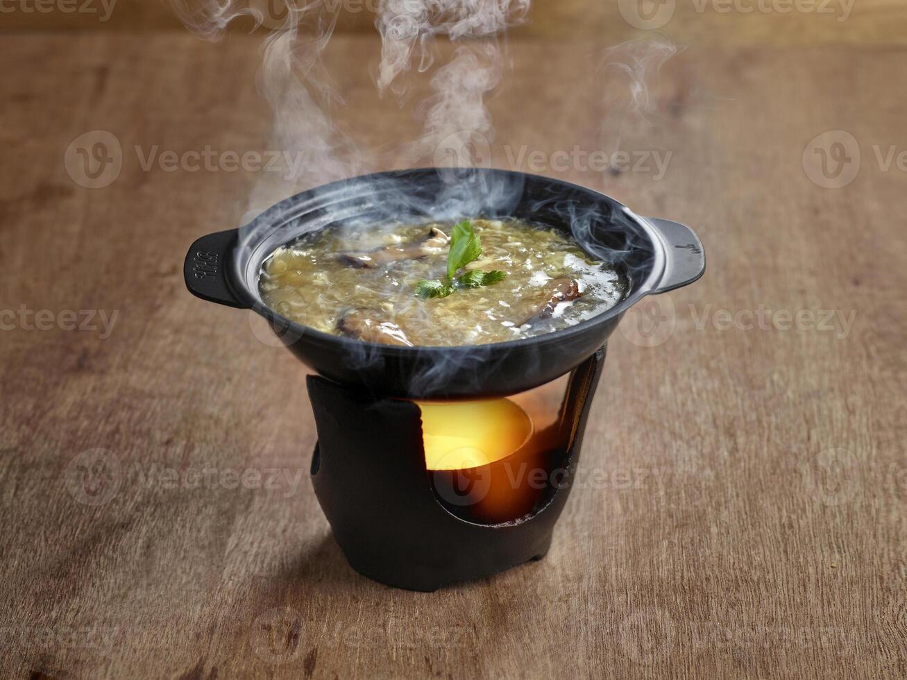 Shark Fin Soup served in stew dish isolated on table side view of soup photo