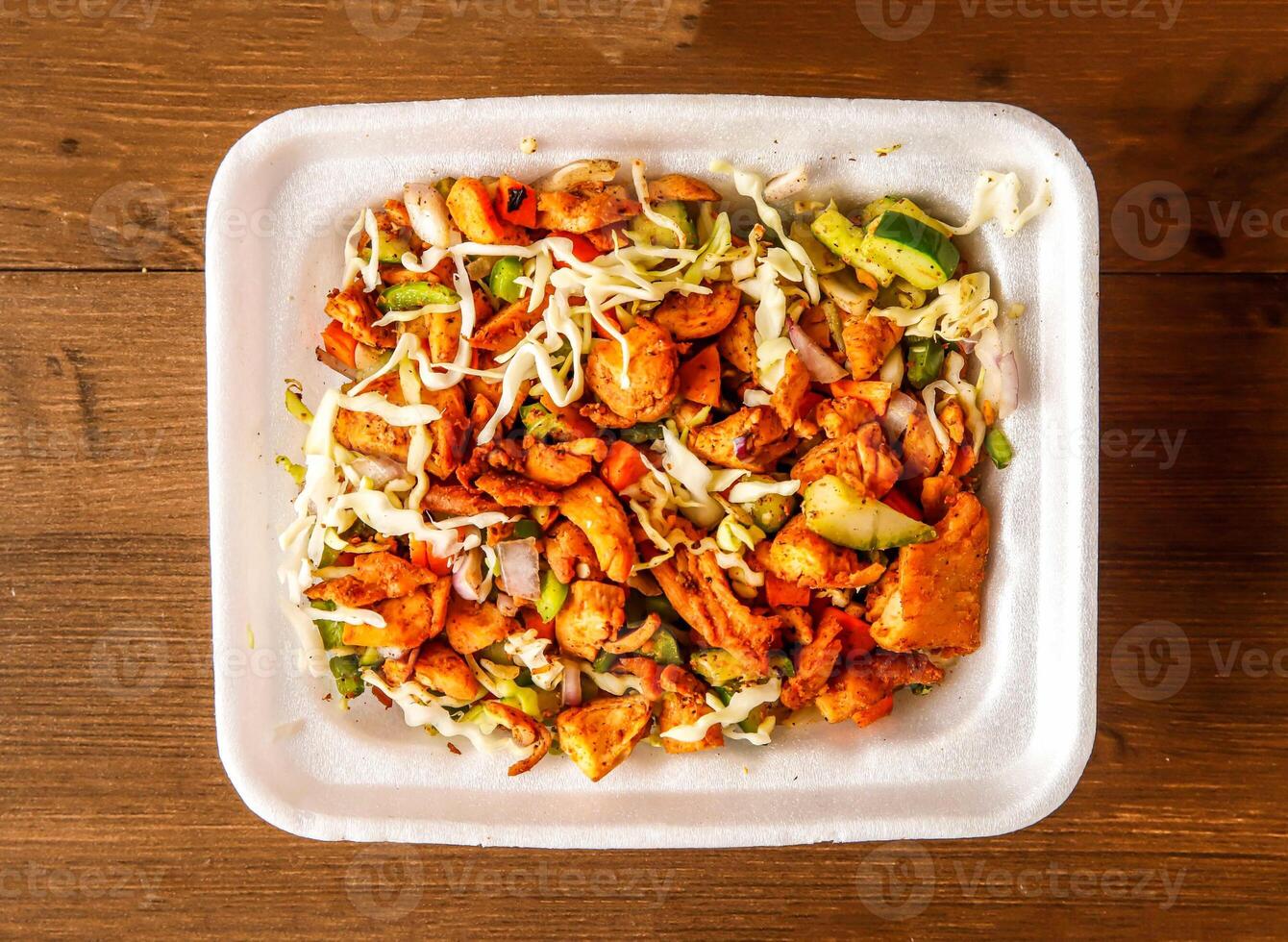 Chicken diet salad with cucumber, cabbage, tomato and onion served in dish isolated on wooden background top view of indian spices and pakistani food photo