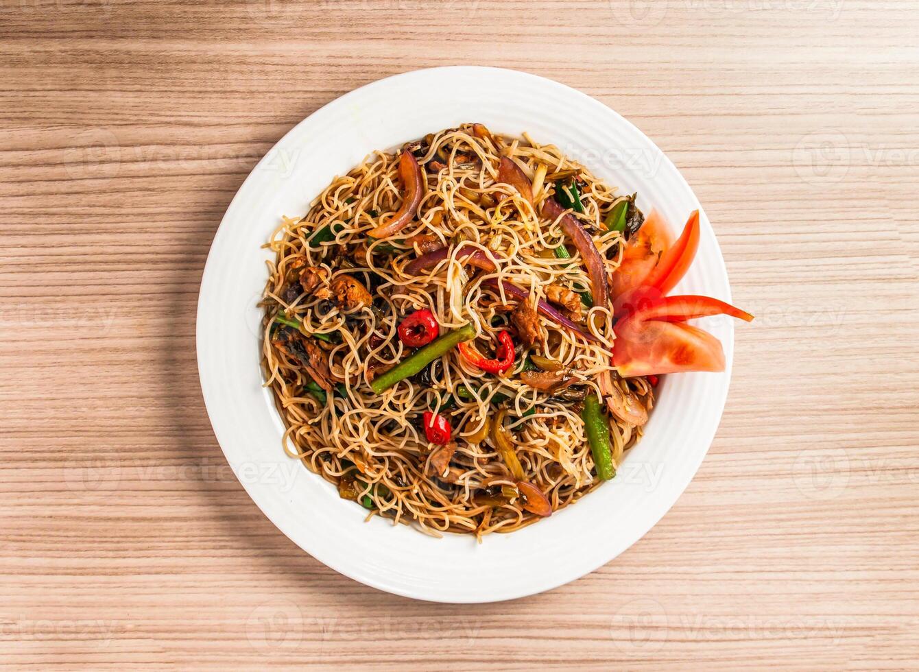 stewed rice vermicelli with pickled cabbage and shredded duck served in dish isolated on table top view of hong kong food photo