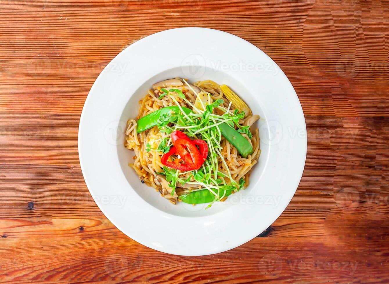 vegetable aglio e olio with baby corn, mushroom and tomato served in dish isolated on wooden table top view of hong kong food photo