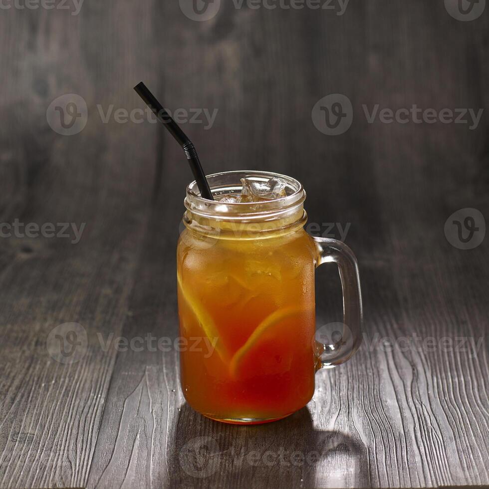 Lemon Tea with straw served in mug isolated on table side view healthy morning drink photo