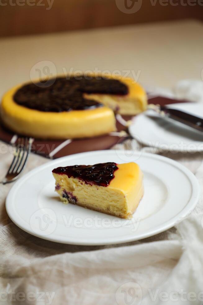Blueberry Cheesecake slice include caramel with fork and knife served in plate isolated on table top view of cafe bake food photo
