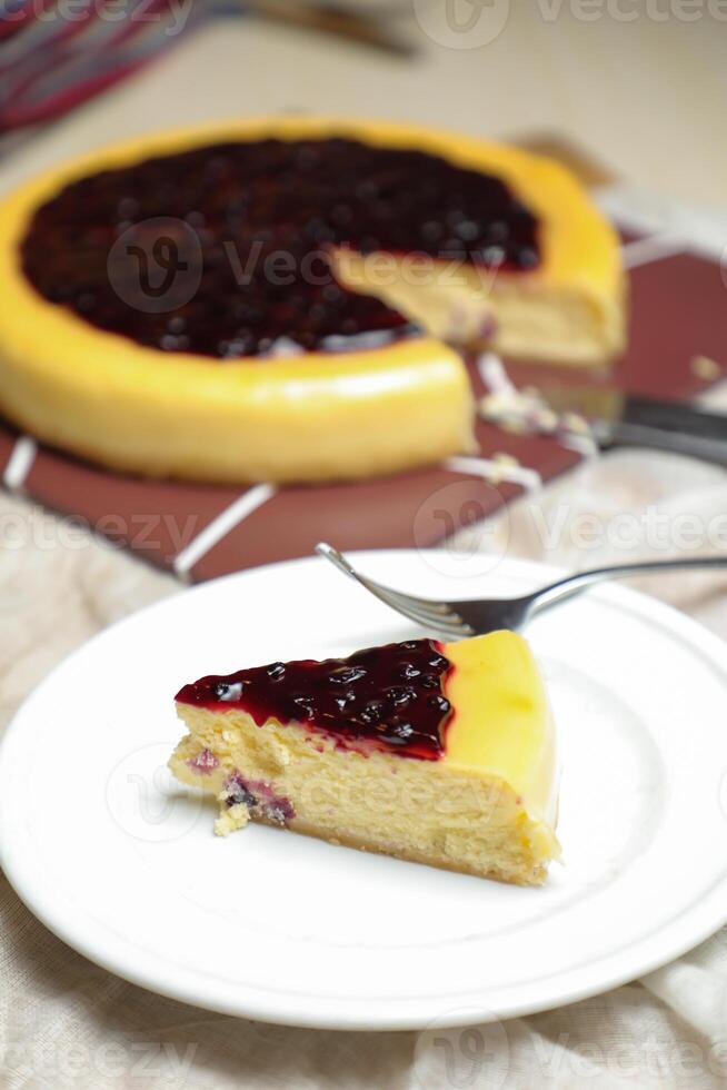 Blueberry Cheesecake slice include caramel with fork and knife served in plate isolated on table top view of cafe bake food photo
