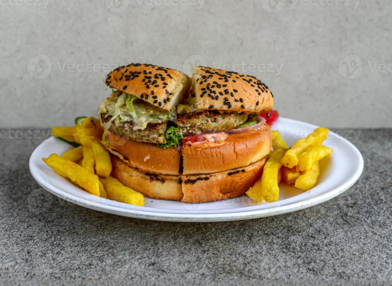 Special chicken burger with french fries served in dish isolated on grey background side view of indian spices and pakistani food photo