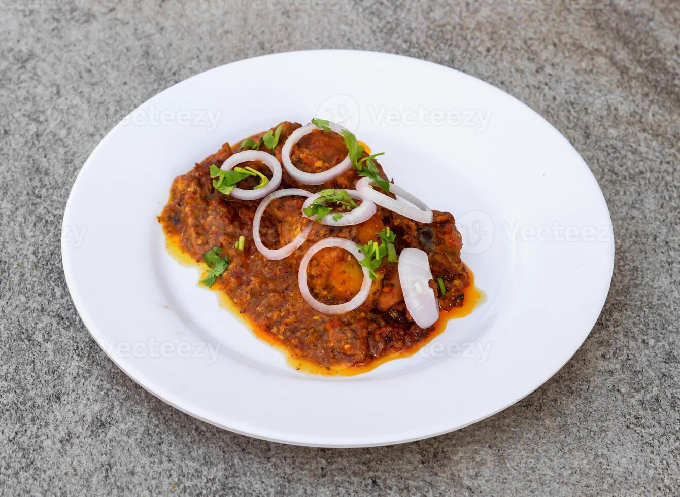 bbq tandoori chicken served in dish isolated on background top view of indian spices and pakistani food photo