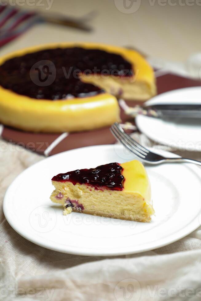 Blueberry Cheesecake slice include caramel with fork and knife served in plate isolated on table top view of cafe bake food photo