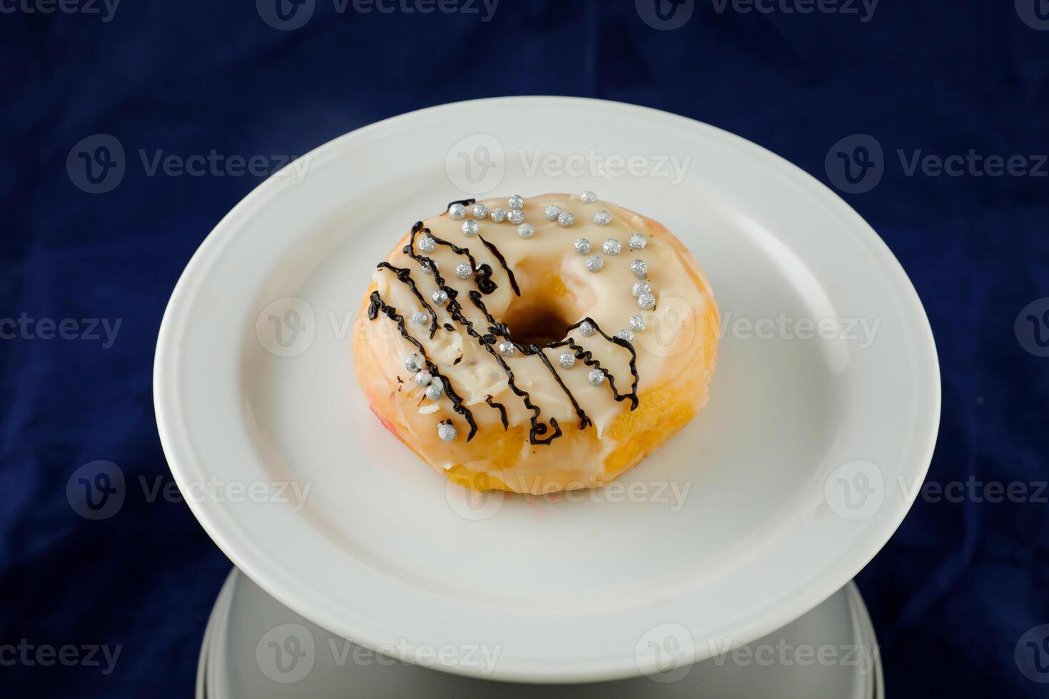 White Chocolate Donut served in plate isolated on background side view of baked food breakfast on table photo
