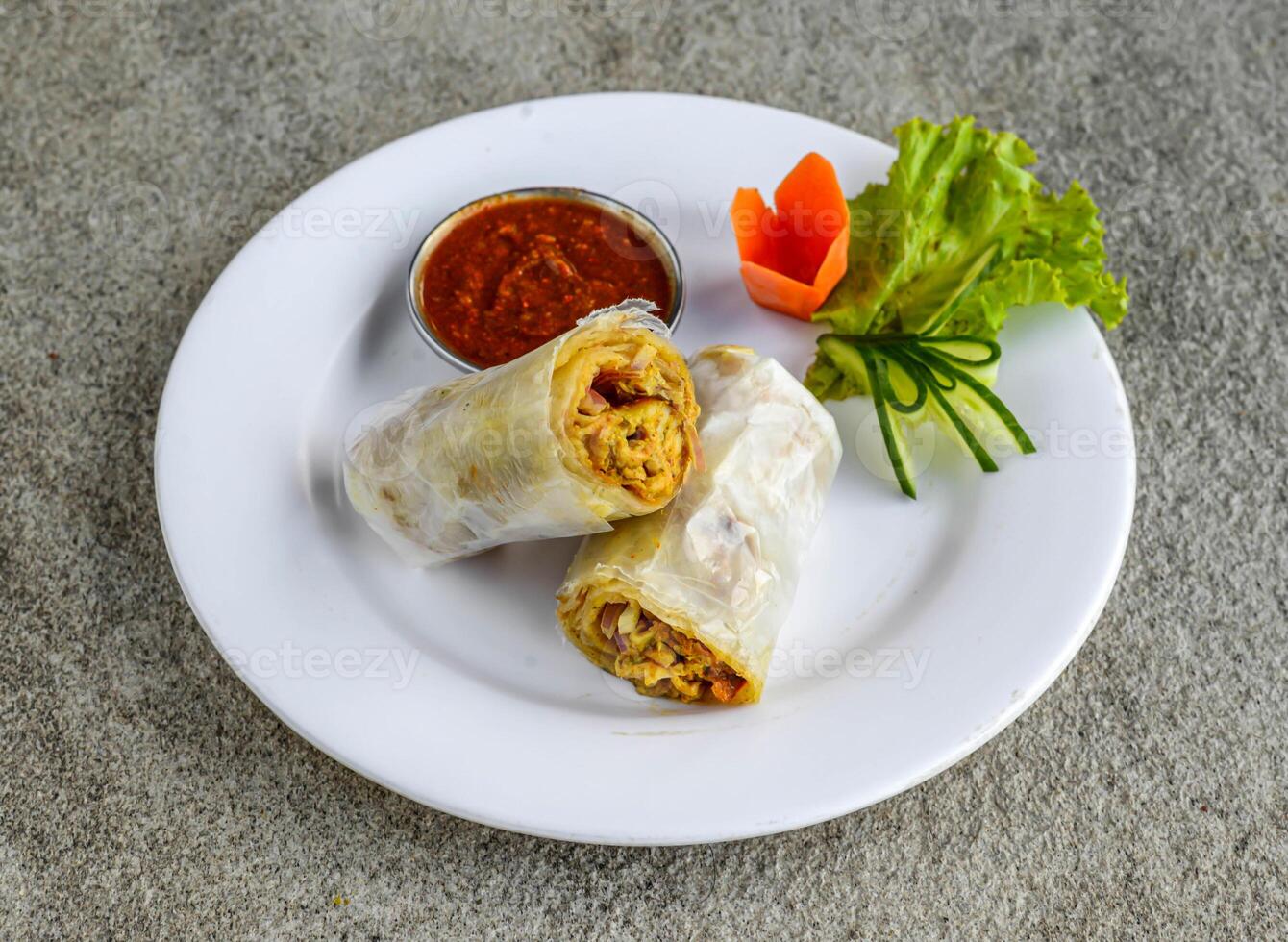 chicken bihari roll with chutney served in dish isolated on grey background side view of indian spices and pakistani food photo