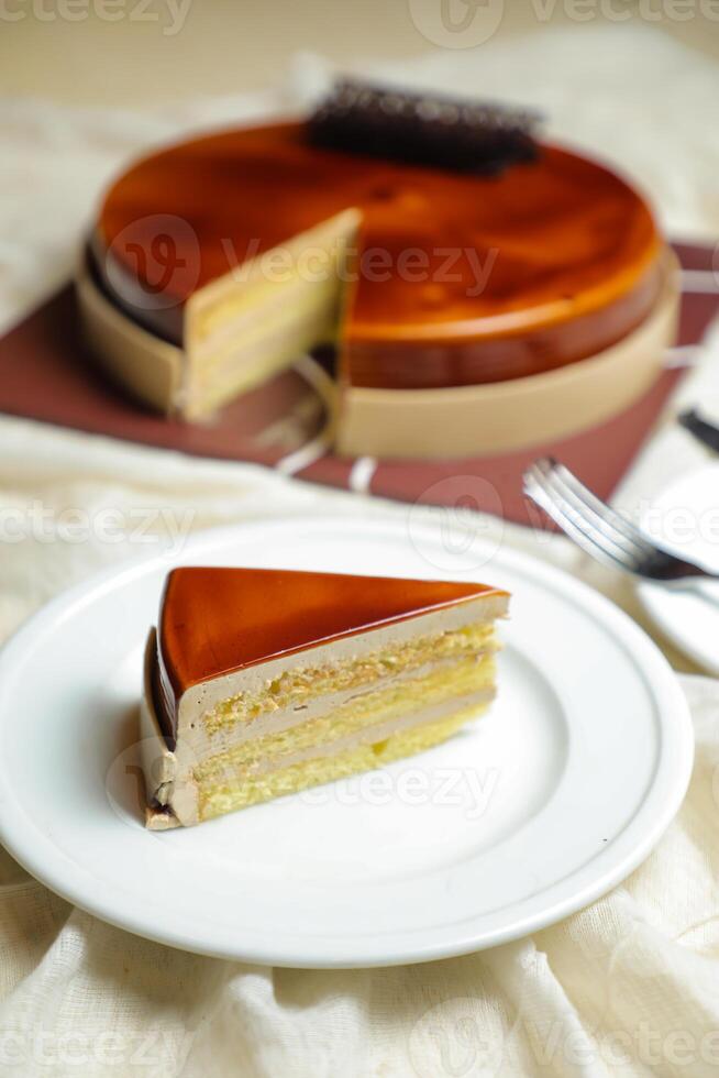 Mocha cake slice include chocolate, cream, sugar with knife and fork served in plate side view of cafe food photo