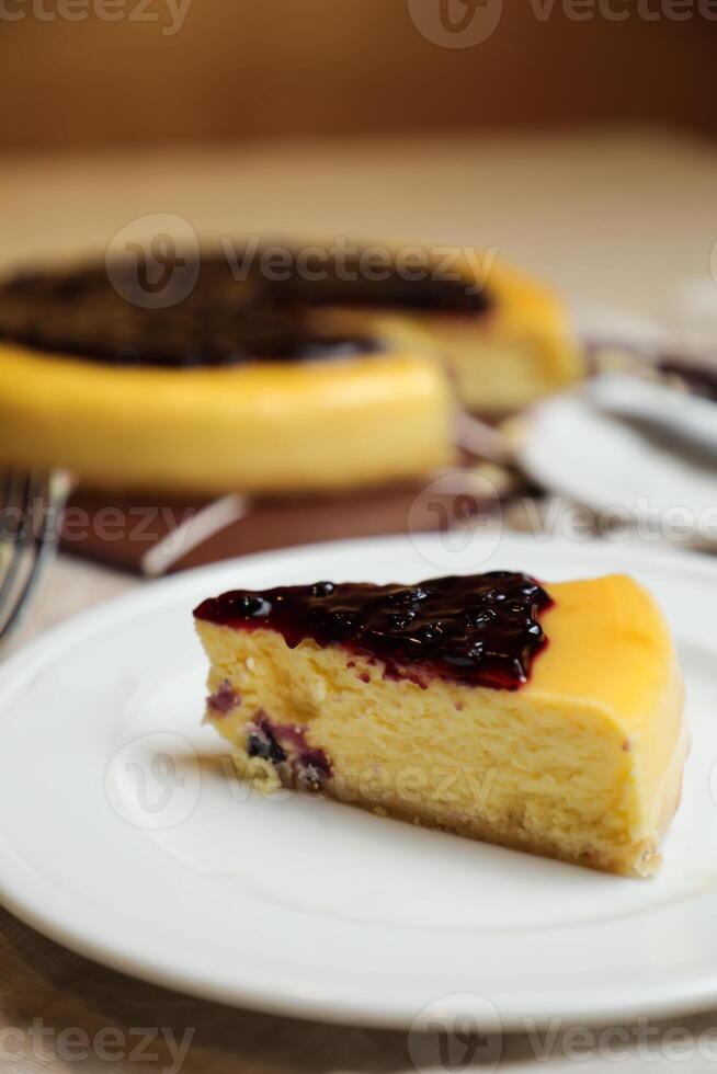 Blueberry Cheesecake slice include caramel with fork and knife served in plate isolated on table top view of cafe bake food photo