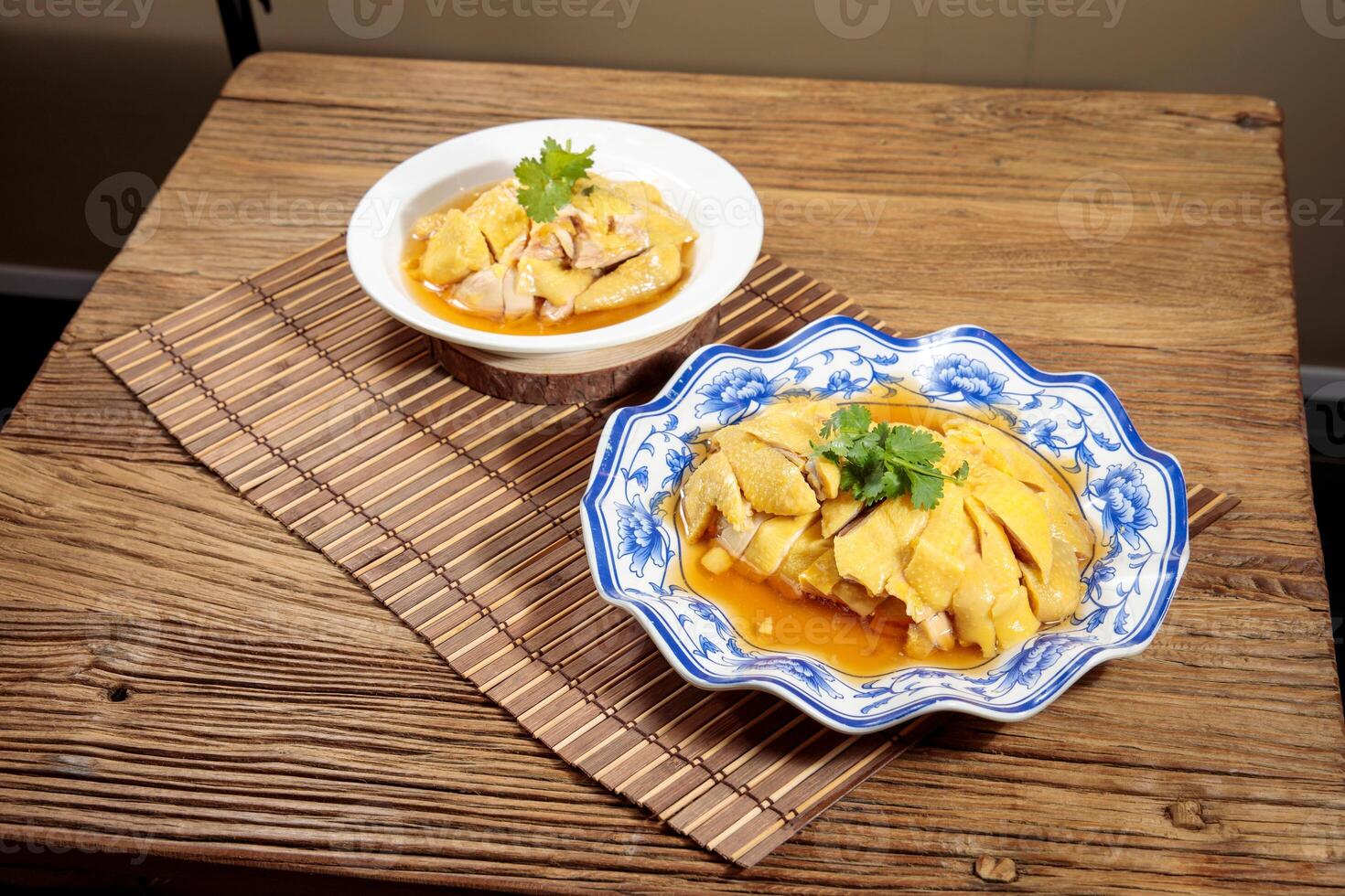 with cChinese Huadiao Drunken Chicken hopsticks served in dish isolated on mat top view on wooden table Hong Kong food photo