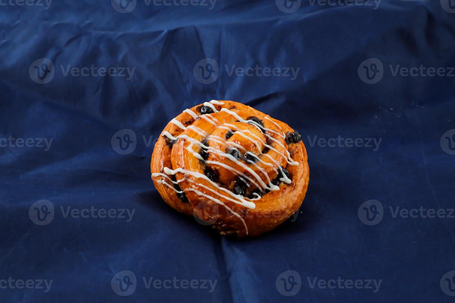 Chocolate Roll isolated on blue background side view of french breakfast baked food item photo