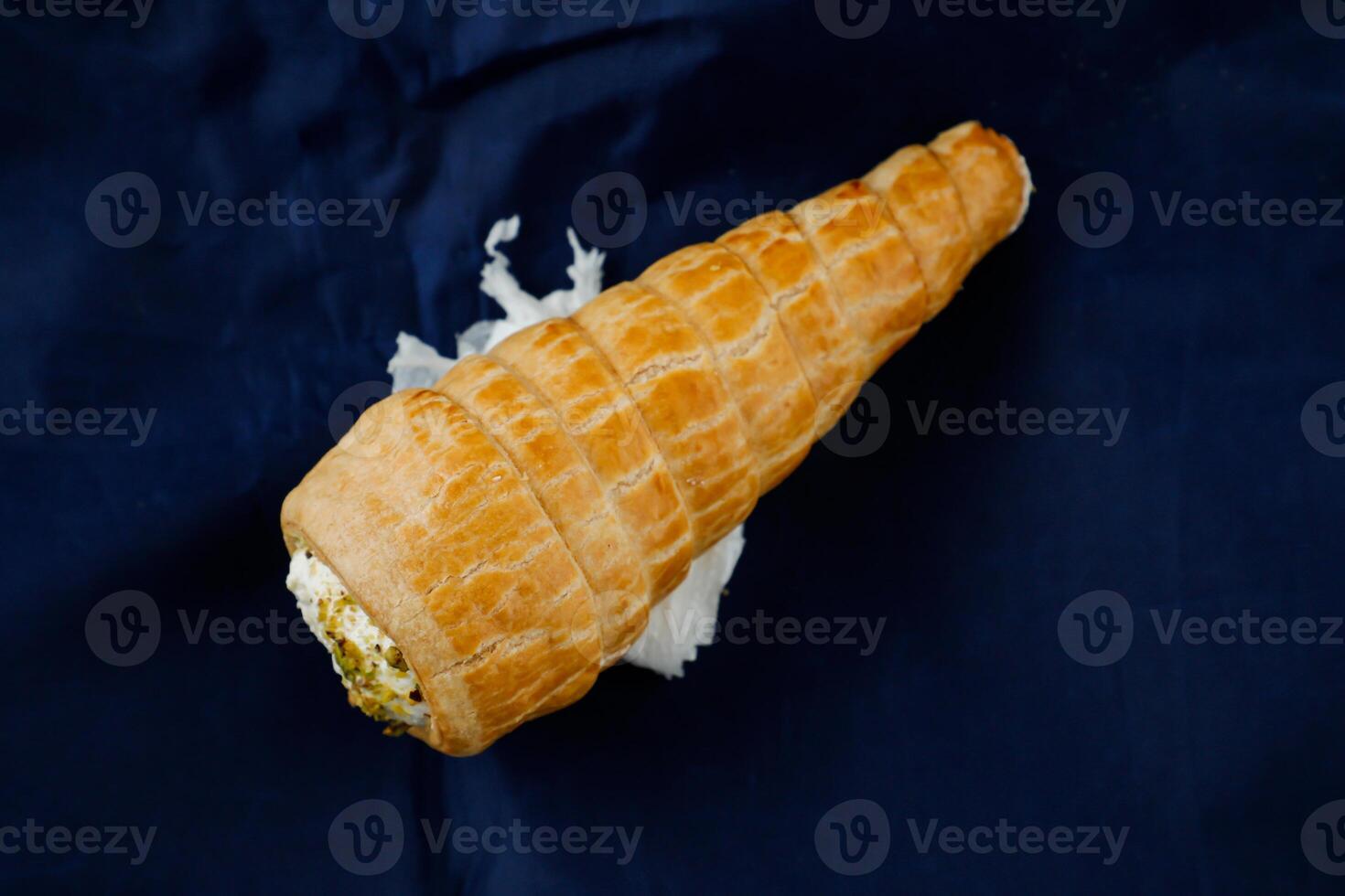 Cream Roll or cream buns isolated on blue napkin top view of french breakfast baked food item photo